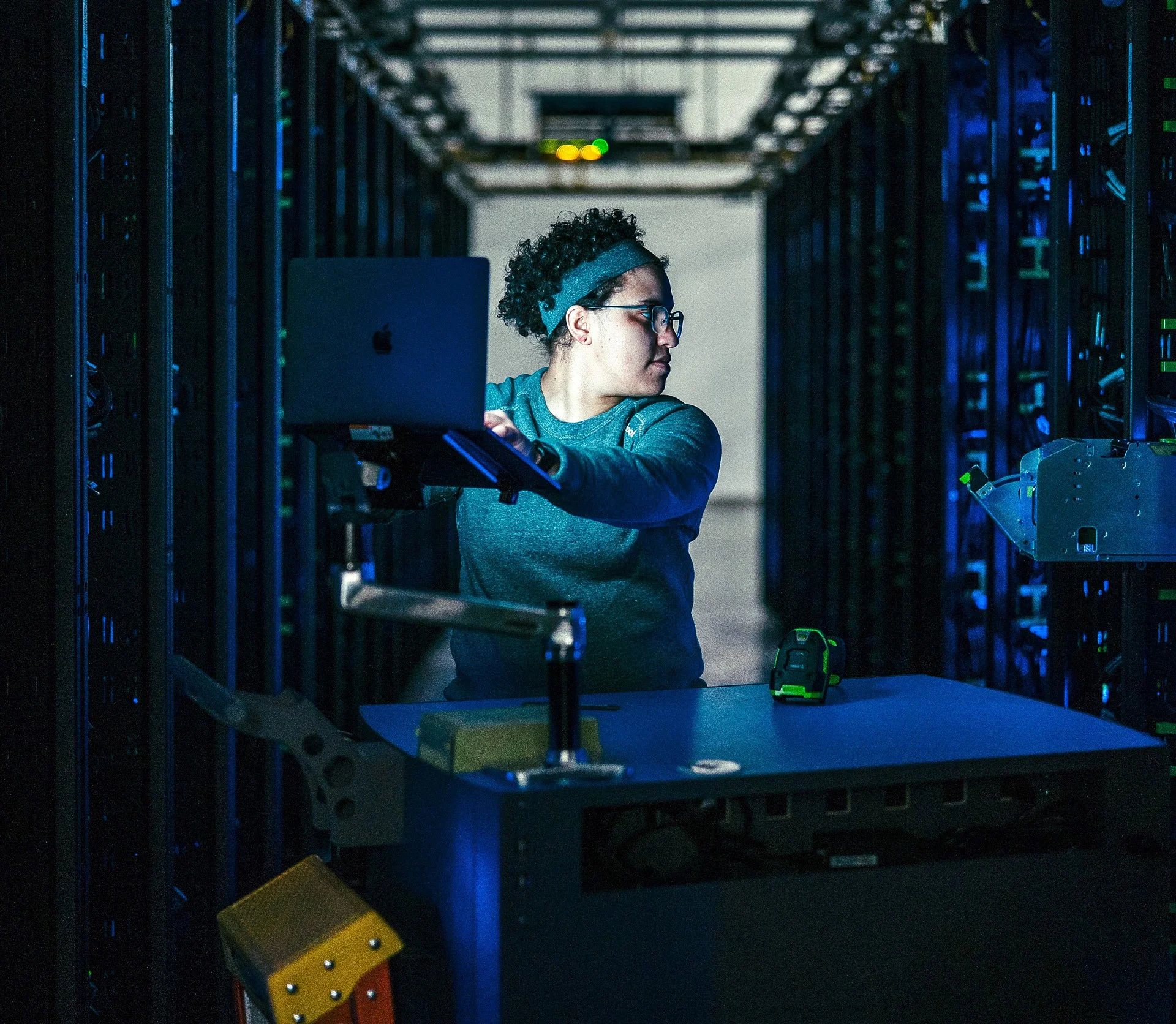 Photo of a person working in a data center